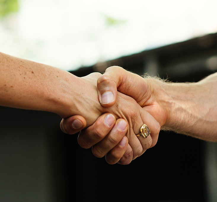 Handshake representing successful sale - Sold Properties